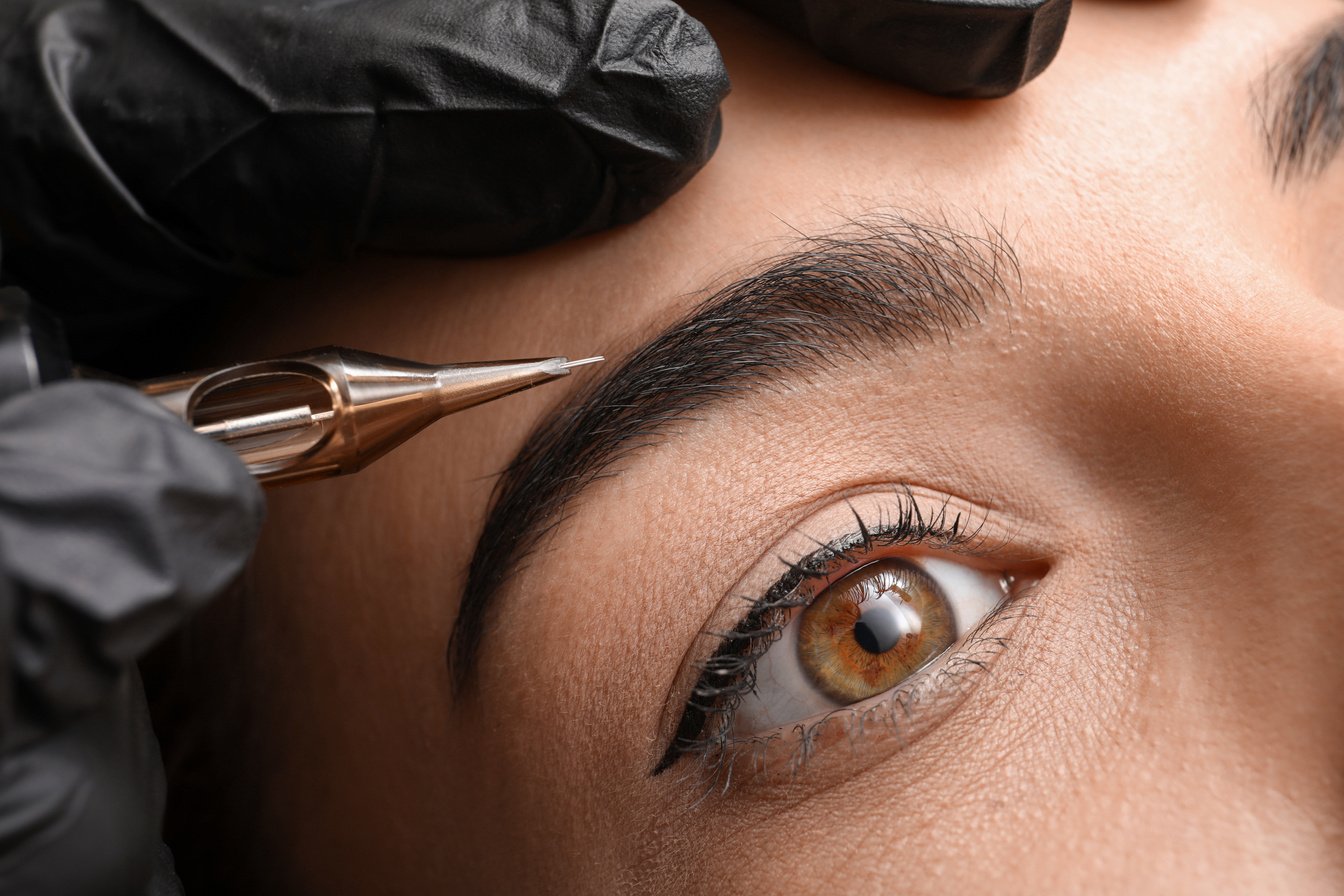 Young Woman Undergoing Procedure of Permanent Eyebrow Makeup in